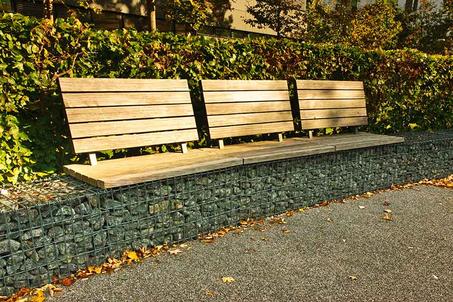 Retaining wall and seating created with gabions filled with natural stone